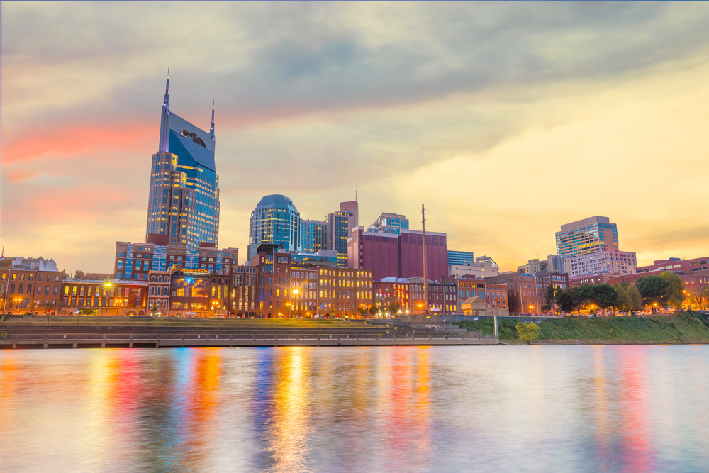 Nashville, Tennessee, downtown skyline with Cumberland River in foreground.