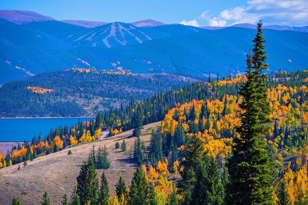 Lake Dillon in fall surrounded by changing leaves.