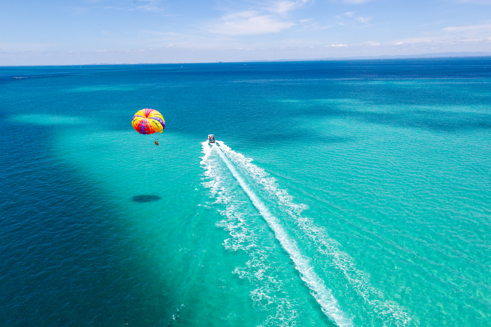 Parasailing in beautiful turquoise water.