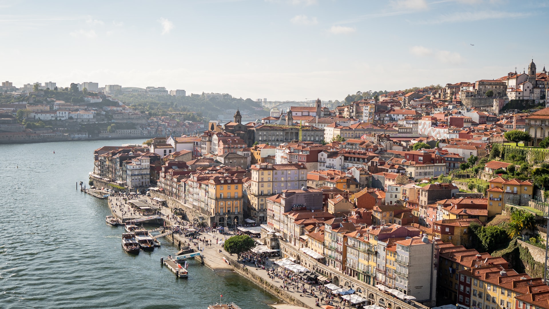 Red-roofed buildings leading down to the waterside in Porto.