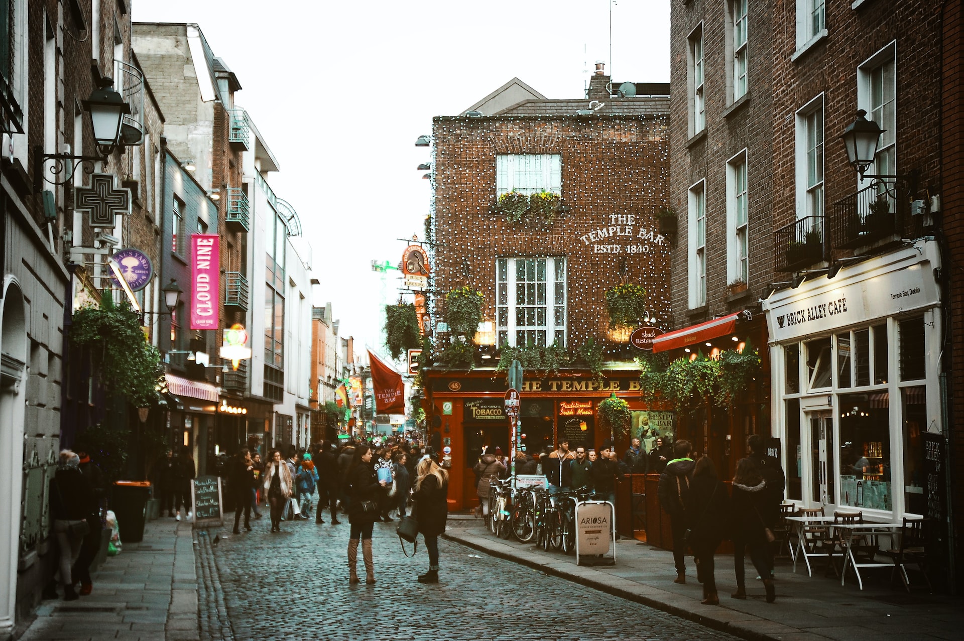 The Temple Bar in Dublin along a cobblestone street in a busy section of town.