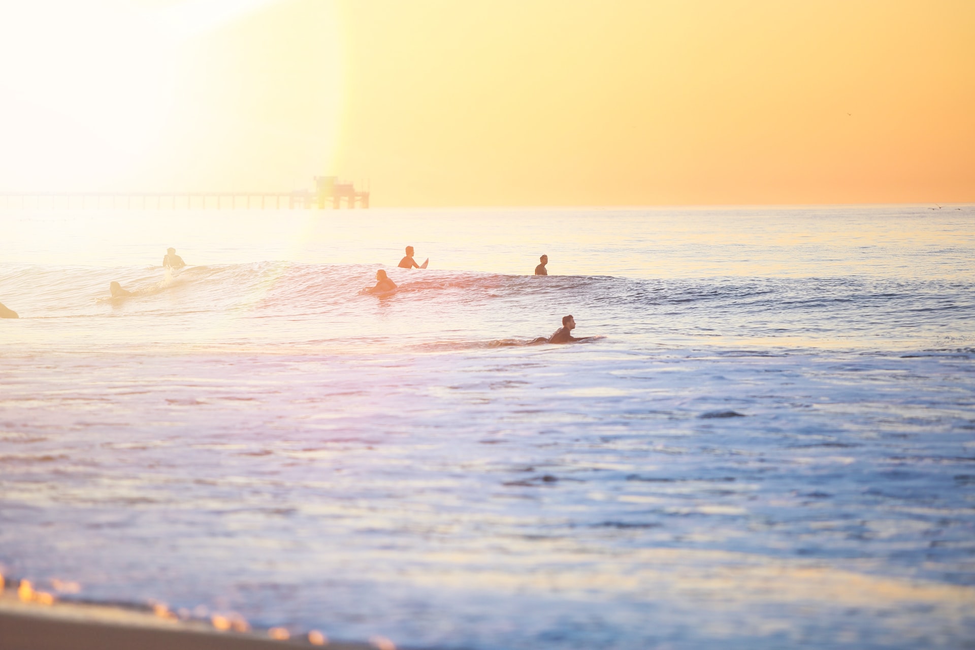 Surfers waiting for a perfect wave on a sunny day.