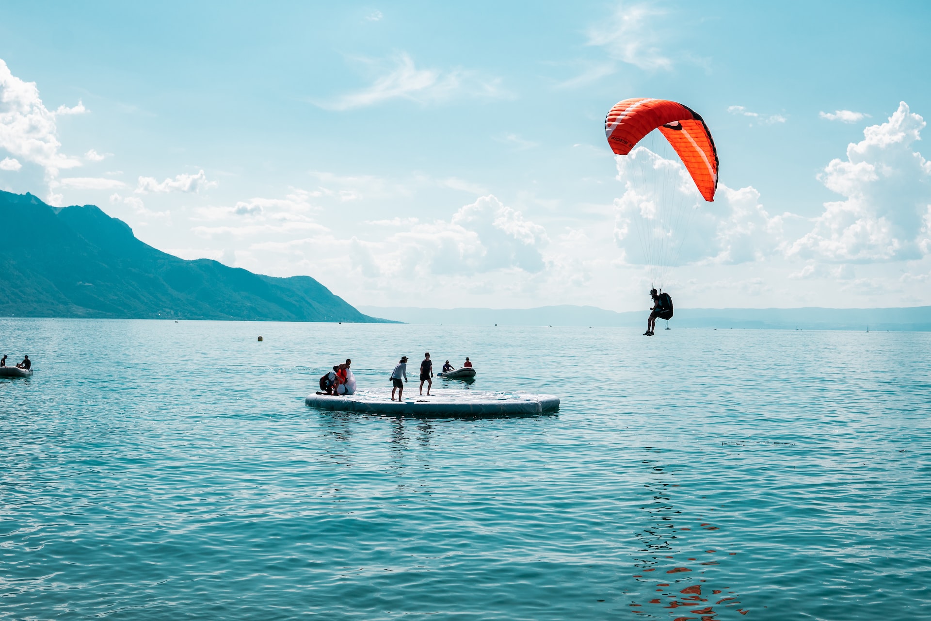 A paraglider landing on a floating dock in Lac Leman.