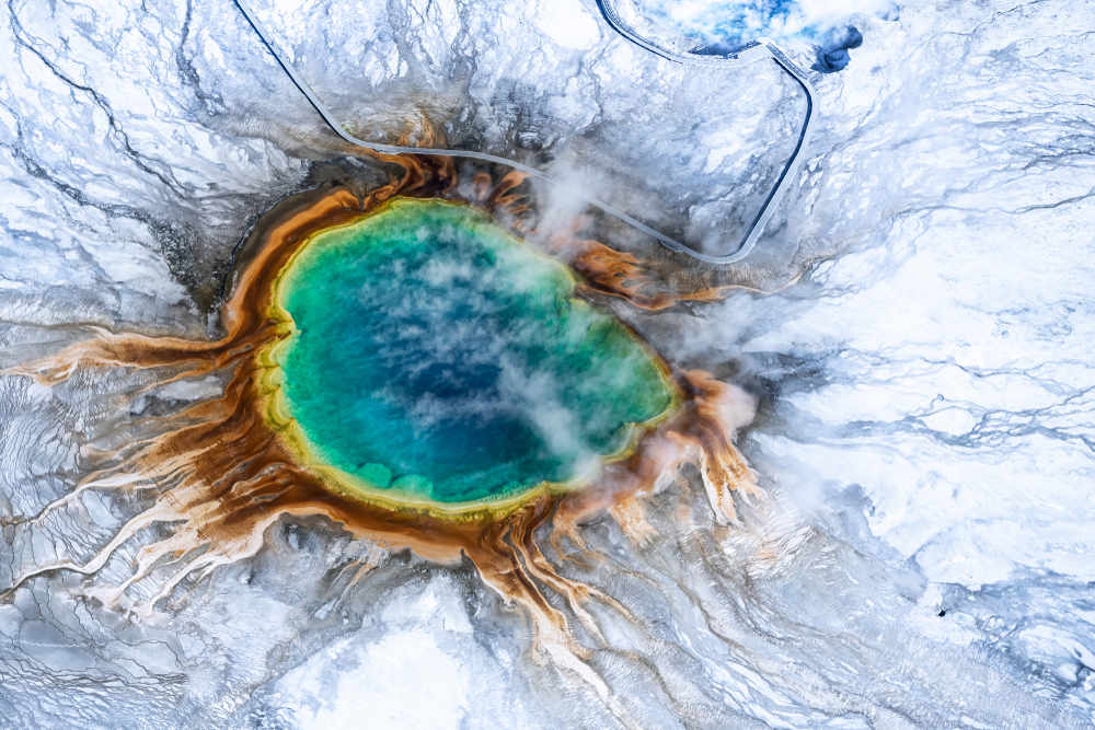 An overhead shot of the Grand Prismatic Spring in winter.