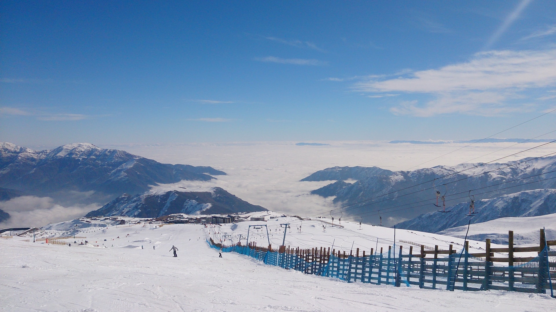 People skiing the Andes mountains on a bluebird day.