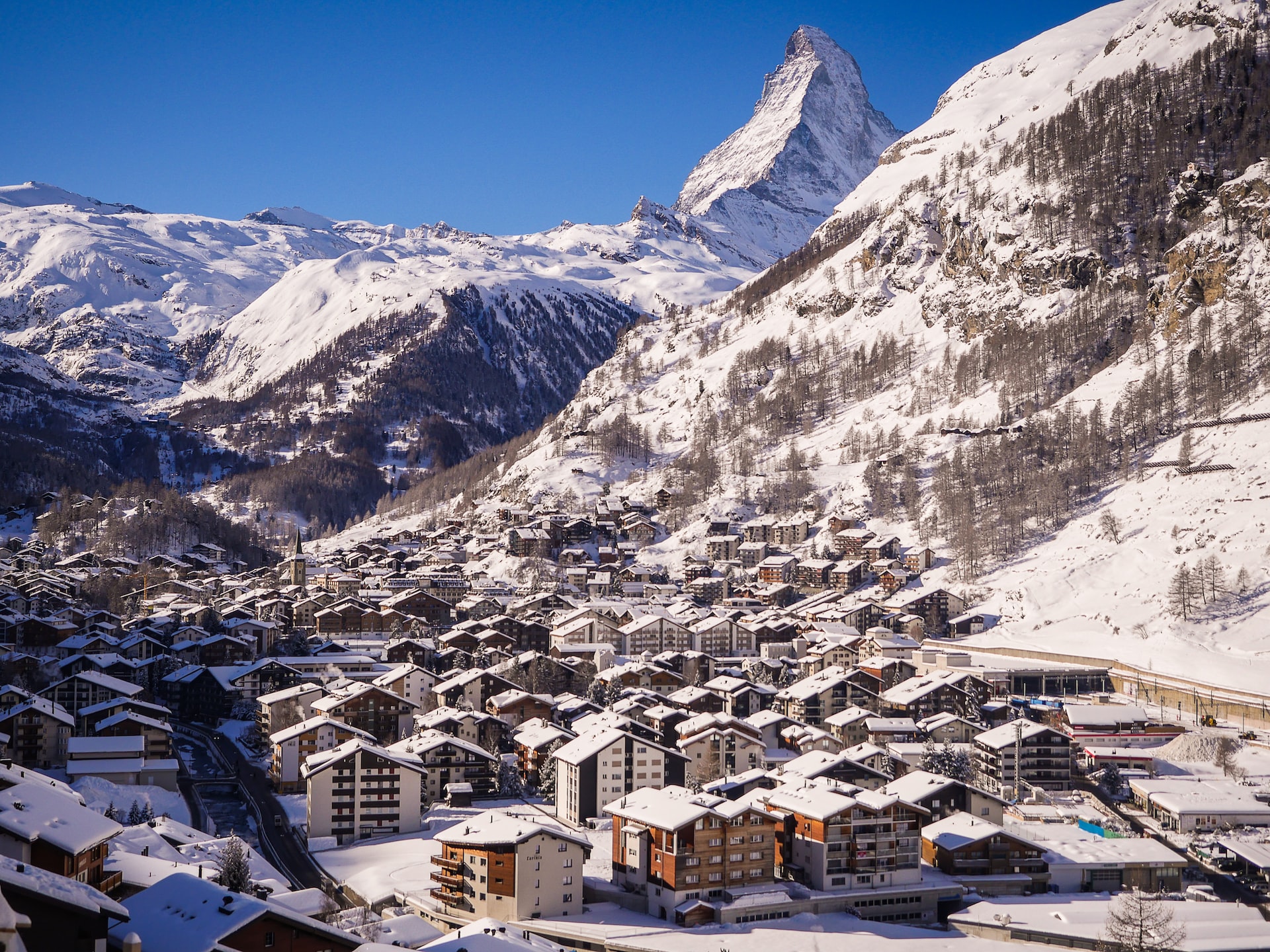 Zermatt covered in snow with the Matterhorn visible in the distance.
