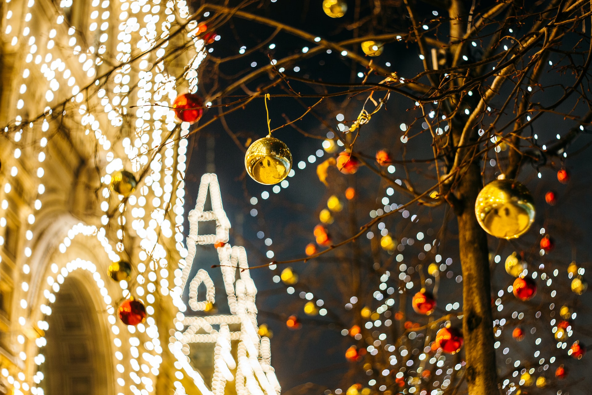 A dazzling display of Christmas lights and ornaments hung up outside.