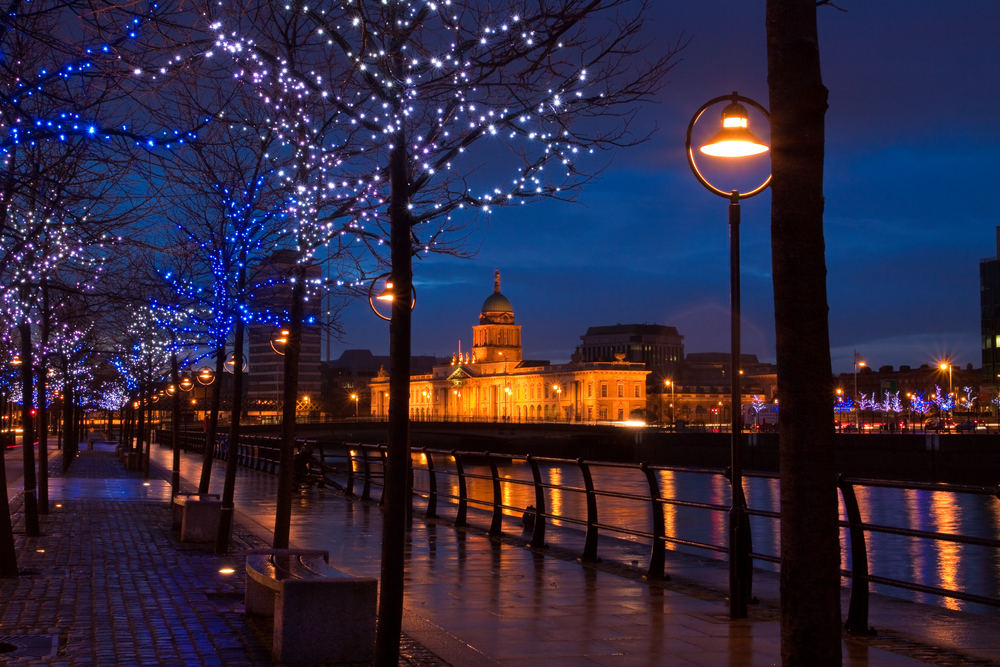 Dublin, Ireland lit up at night with colorful, sparkling lights.