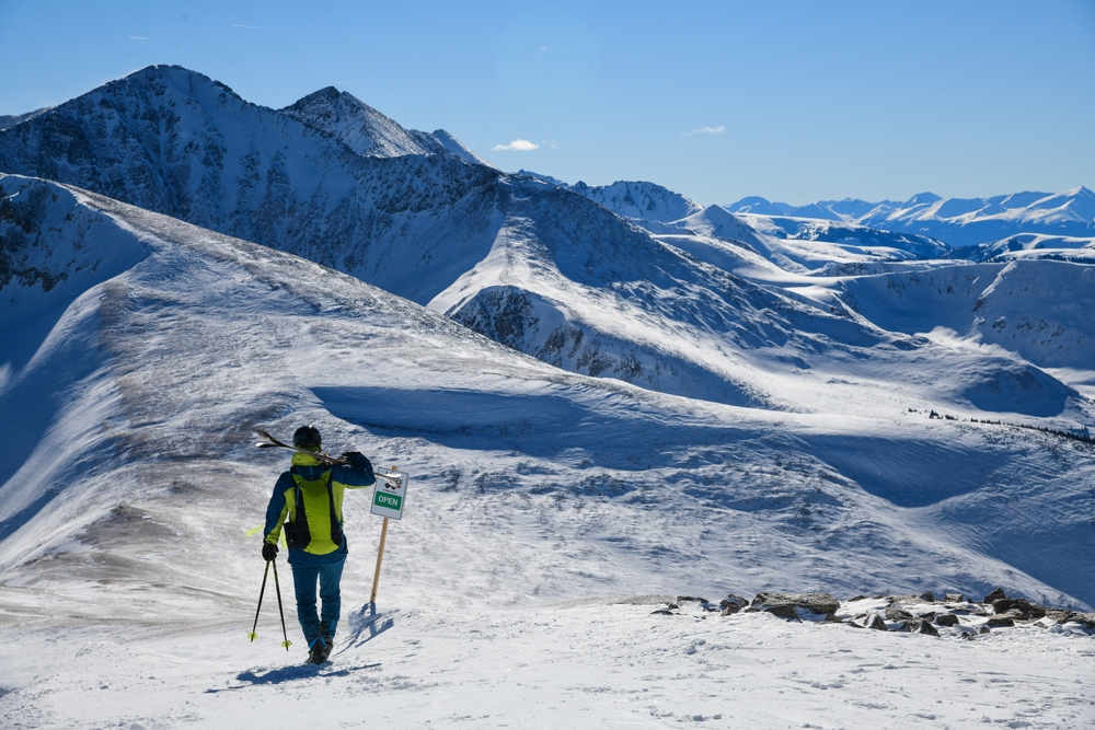 Skier standing on the top of Peak 8 at the Breckenridge Ski Resort in Colorado.