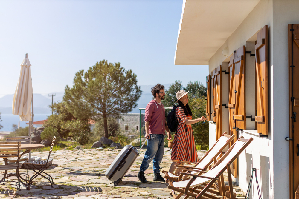 Young couple arriving at vacation rental home.