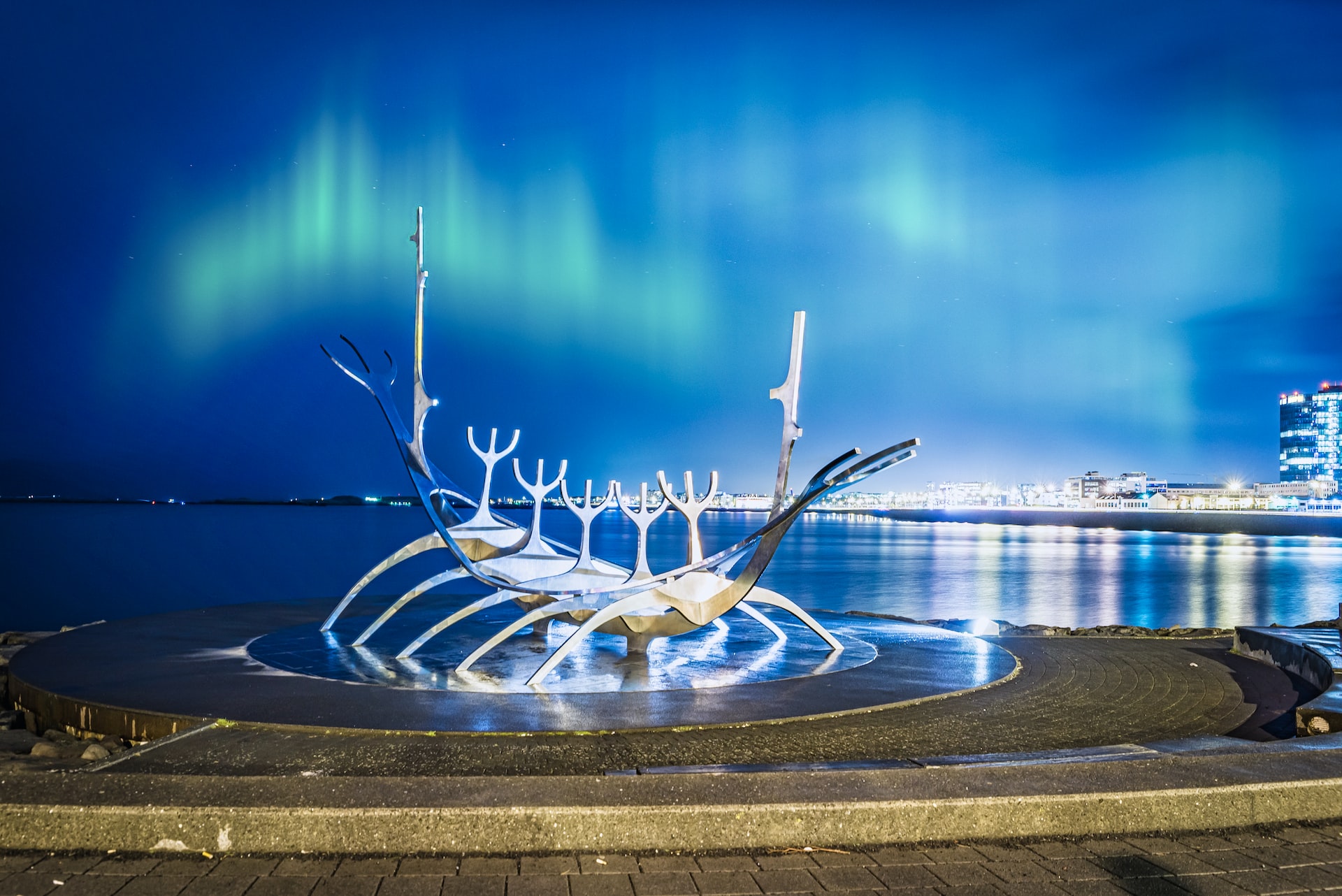 The Sun Voyager sculpture with the Northern Lights above the city of Reykjavík, Iceland.