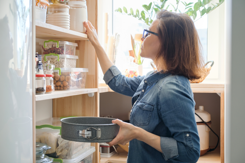 A woman checking the pantry.