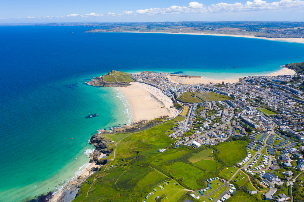 Aerial shot of St. Ives with its beaches and seaside community.