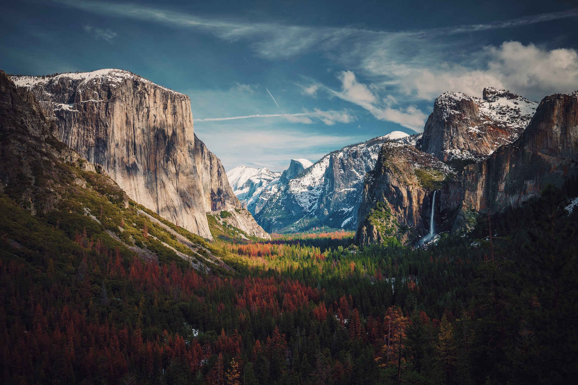 Half Dome in Yosemite visible in the far distance through a valley.