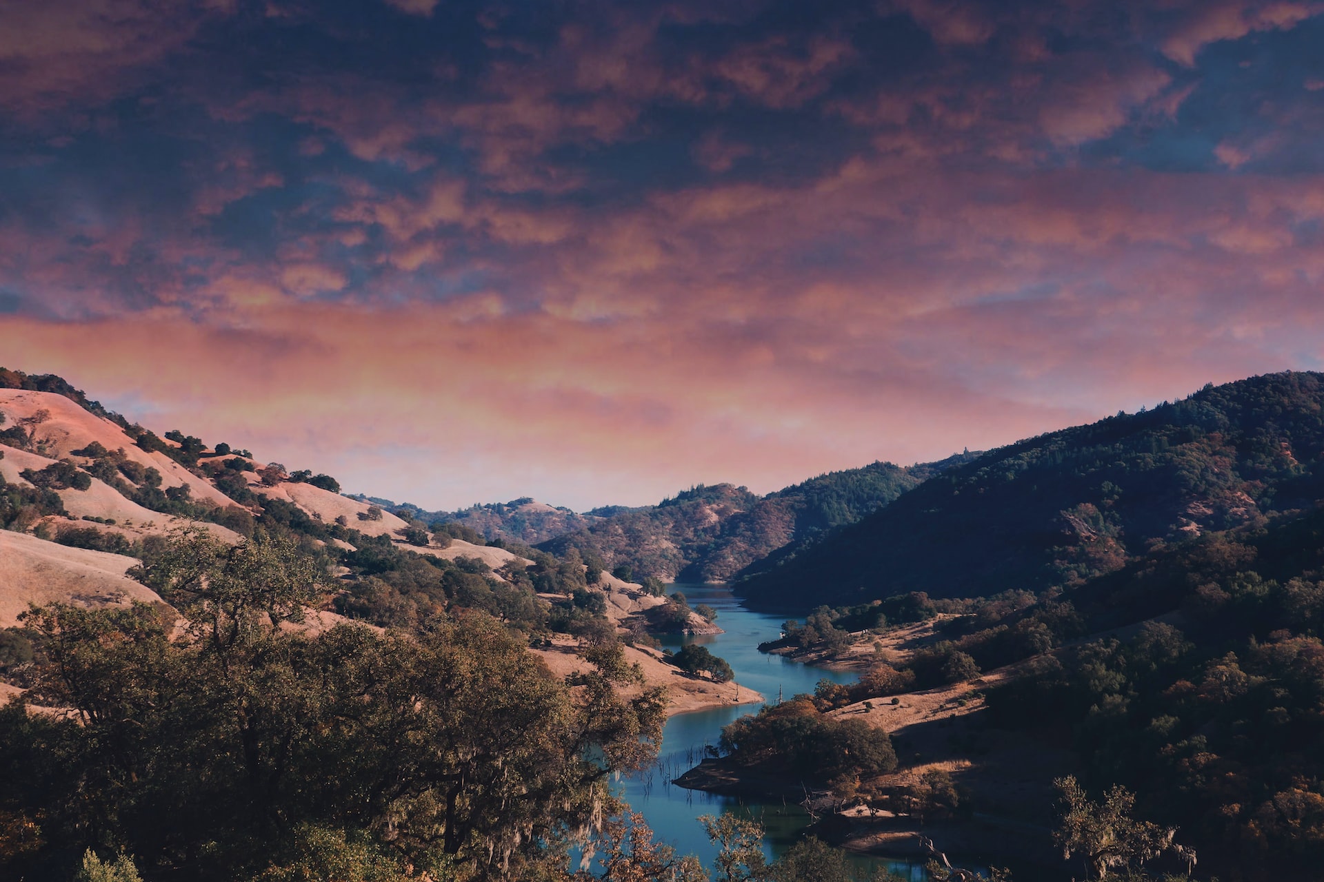 Lake in the middle of the mountains during sunset.