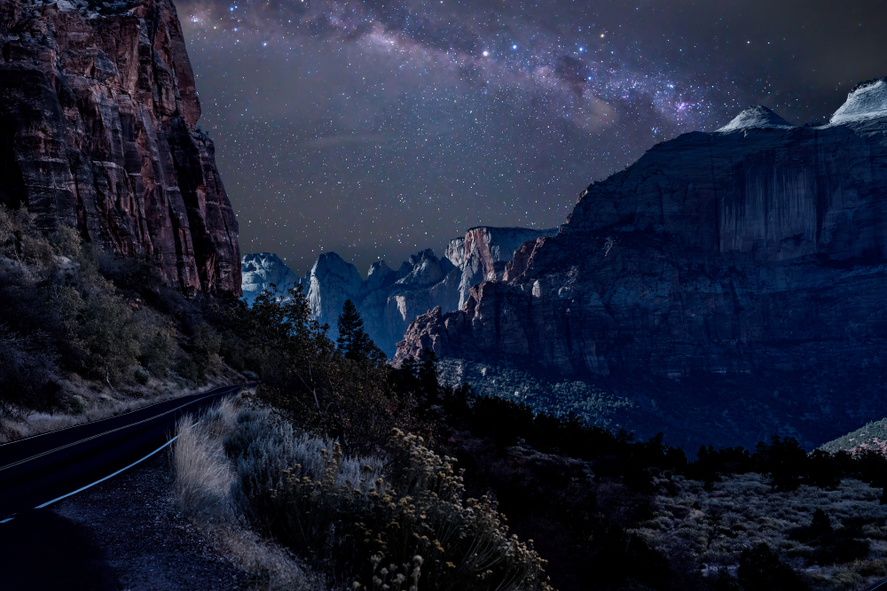 Scenic Byway Route 9 in Zion National Park at night near Springdale, Utah. Stars illuminate the night sky overhead.