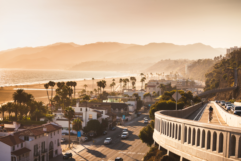 Hazy sunset in Santa Monica with views of the beach, the Pacific Ocean, and highway.