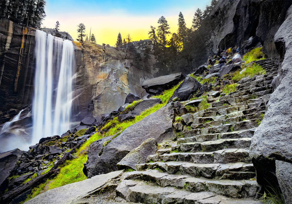 Vernal Falls at dawn, stone steps running up the side of a mountain in Yosemite National Park, California.