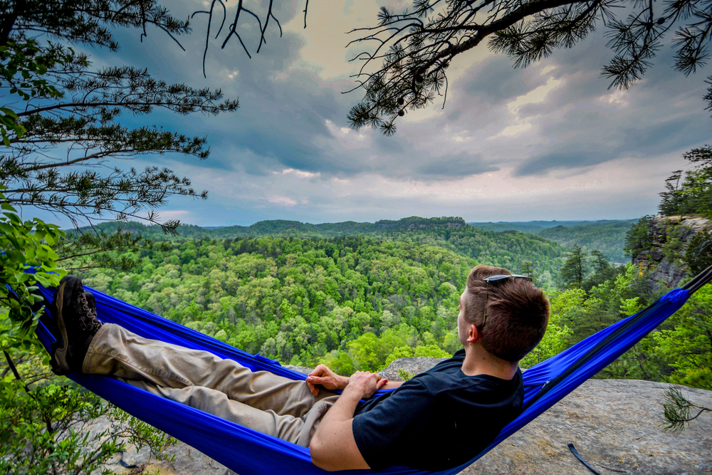 A man relaxes in a hammock on a ridgeline in Kentucky.