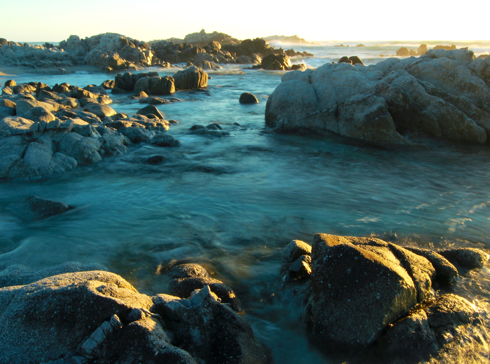 Romantic sunset along rocky coastline of Asilomar State Reserve, Pacific Grove near Monterey and Carmel, California.