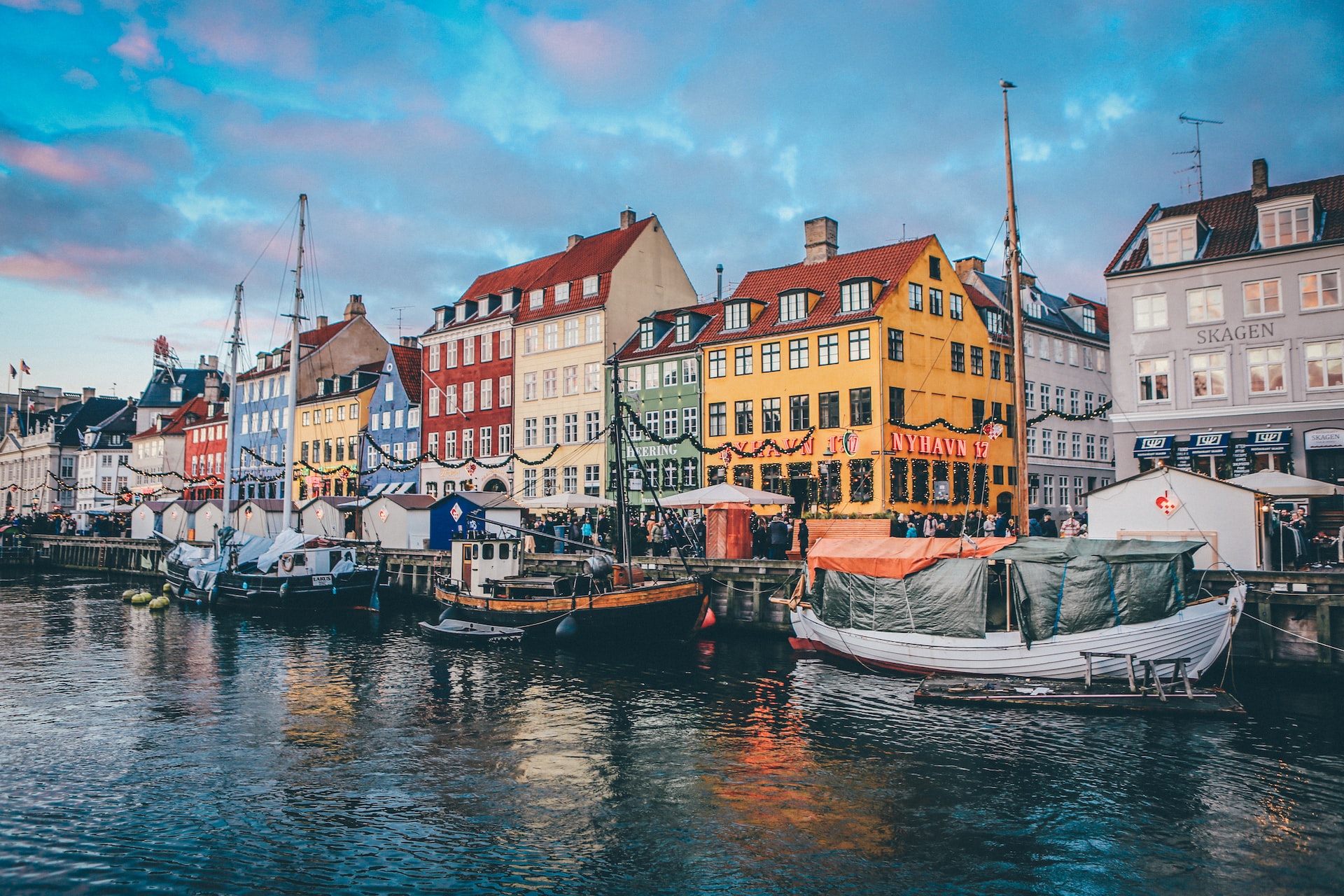 A series of colorful buildings and boats along the waterfront in Copenhagen.