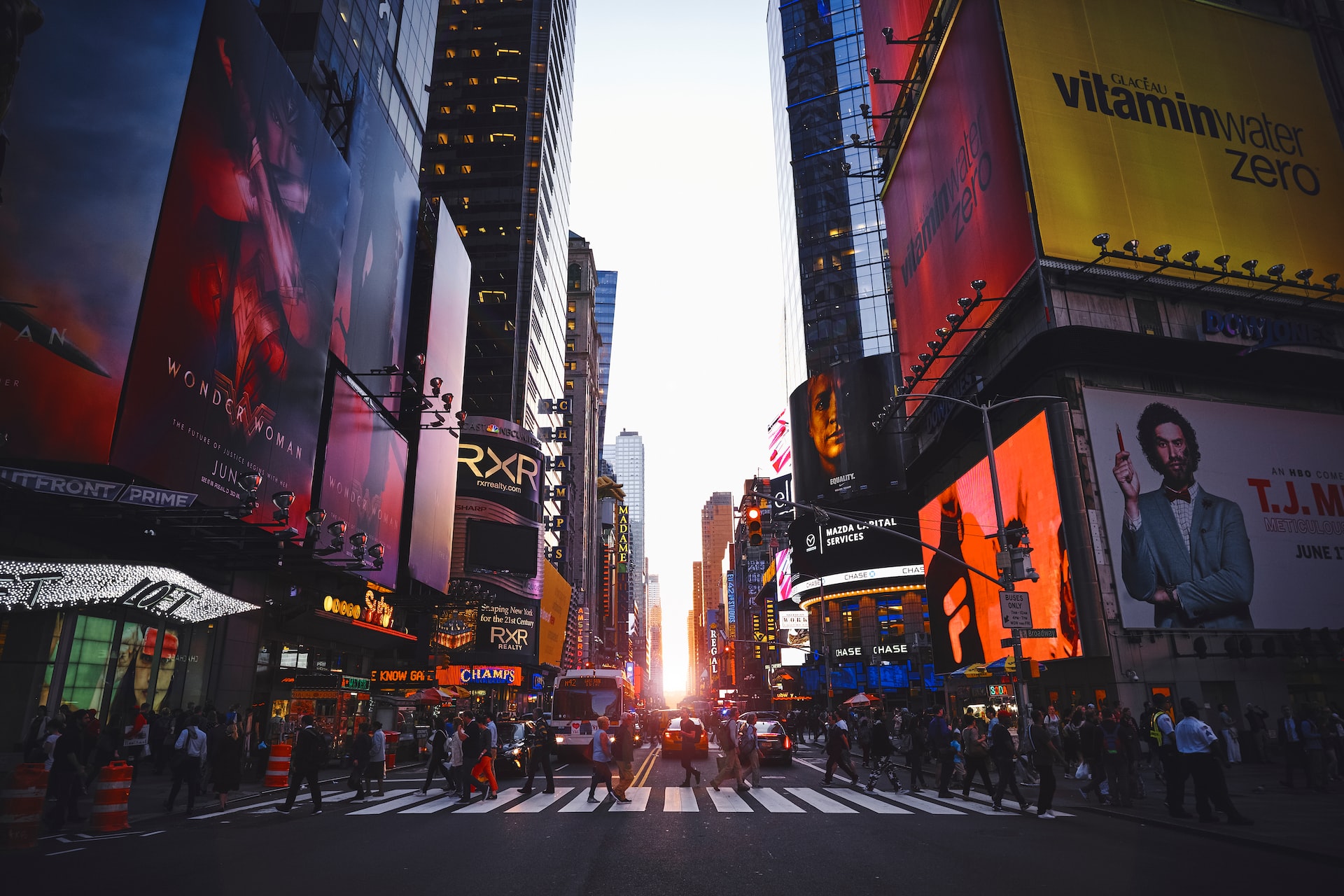 Times Square, New York, with people walking across the crosswalk.