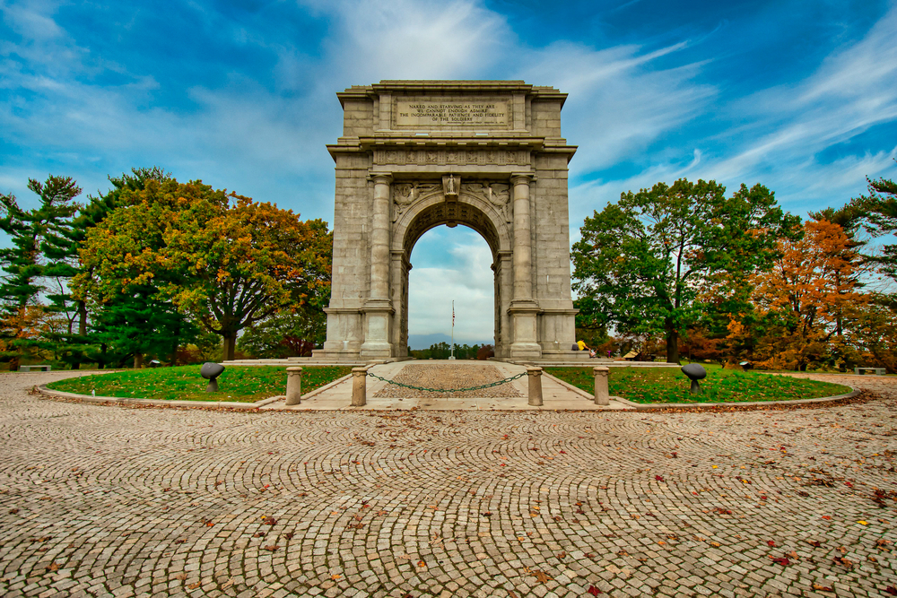 The National Memorial Arch at Valley Forge National Historical Park on an autumn day with clear blue skies.