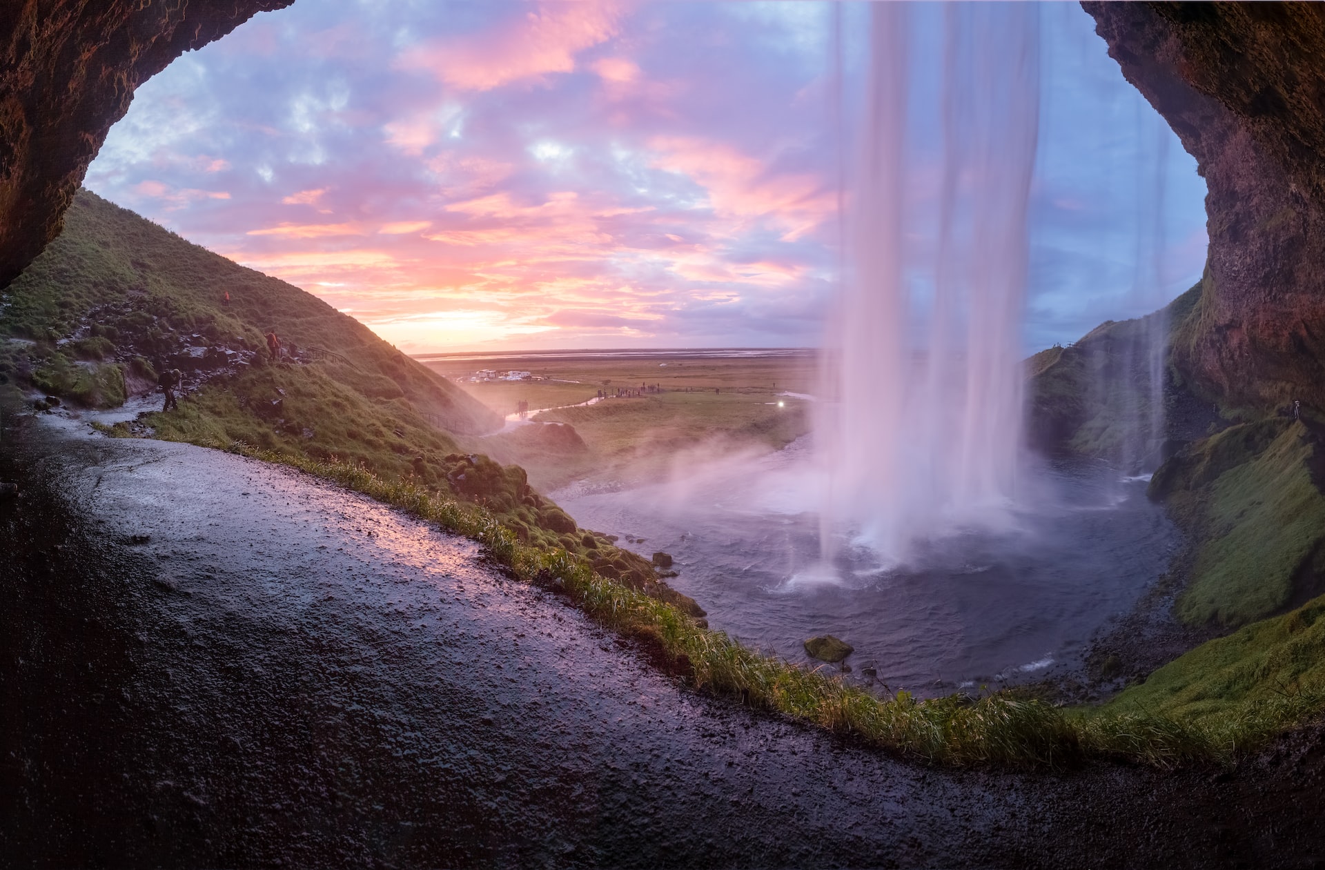 The Seljalandsfoss waterfall in Iceland painted pink thanks to a setting sun.