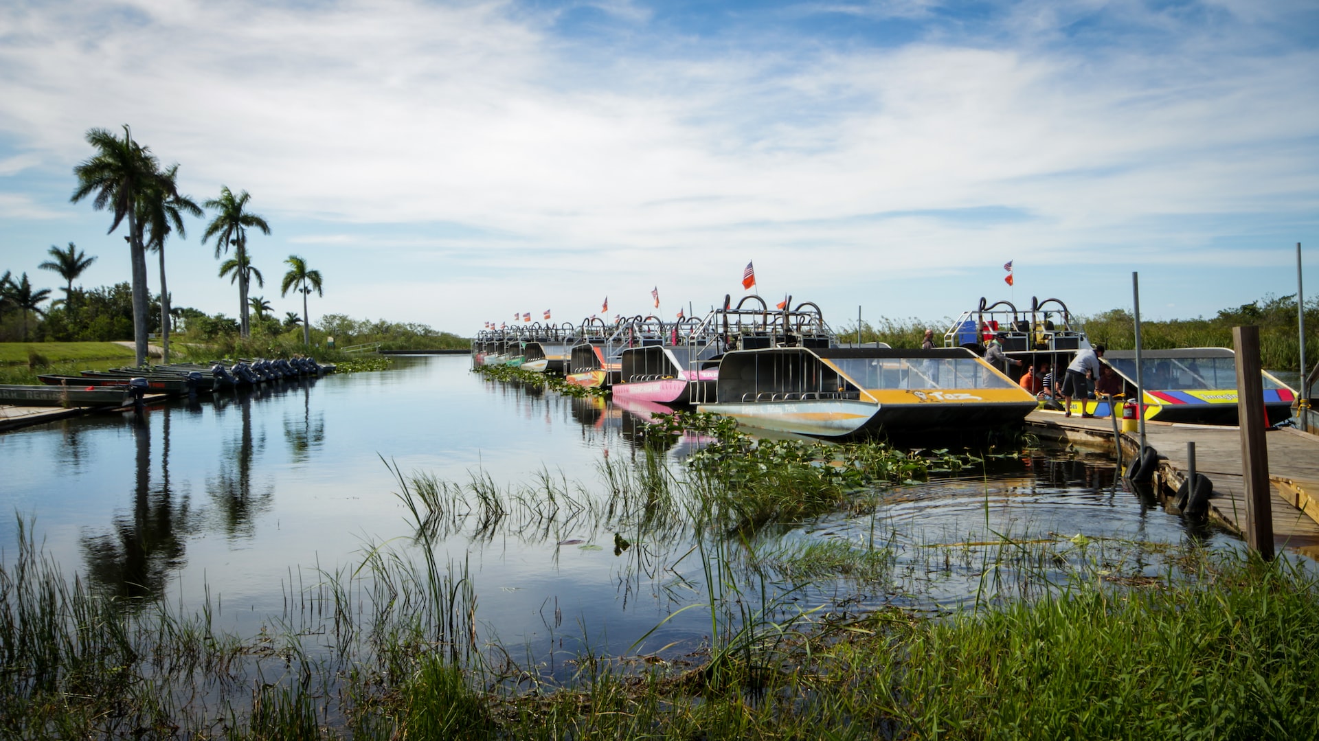 A series of colorful fan boats in the Everglades.