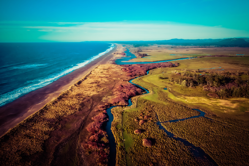 Aerial view of New River in Southern Oregon, originating at Floras Lake and running parallel to the Pacific Ocean for eight miles, entering the ocean between Bandon and Langlois.