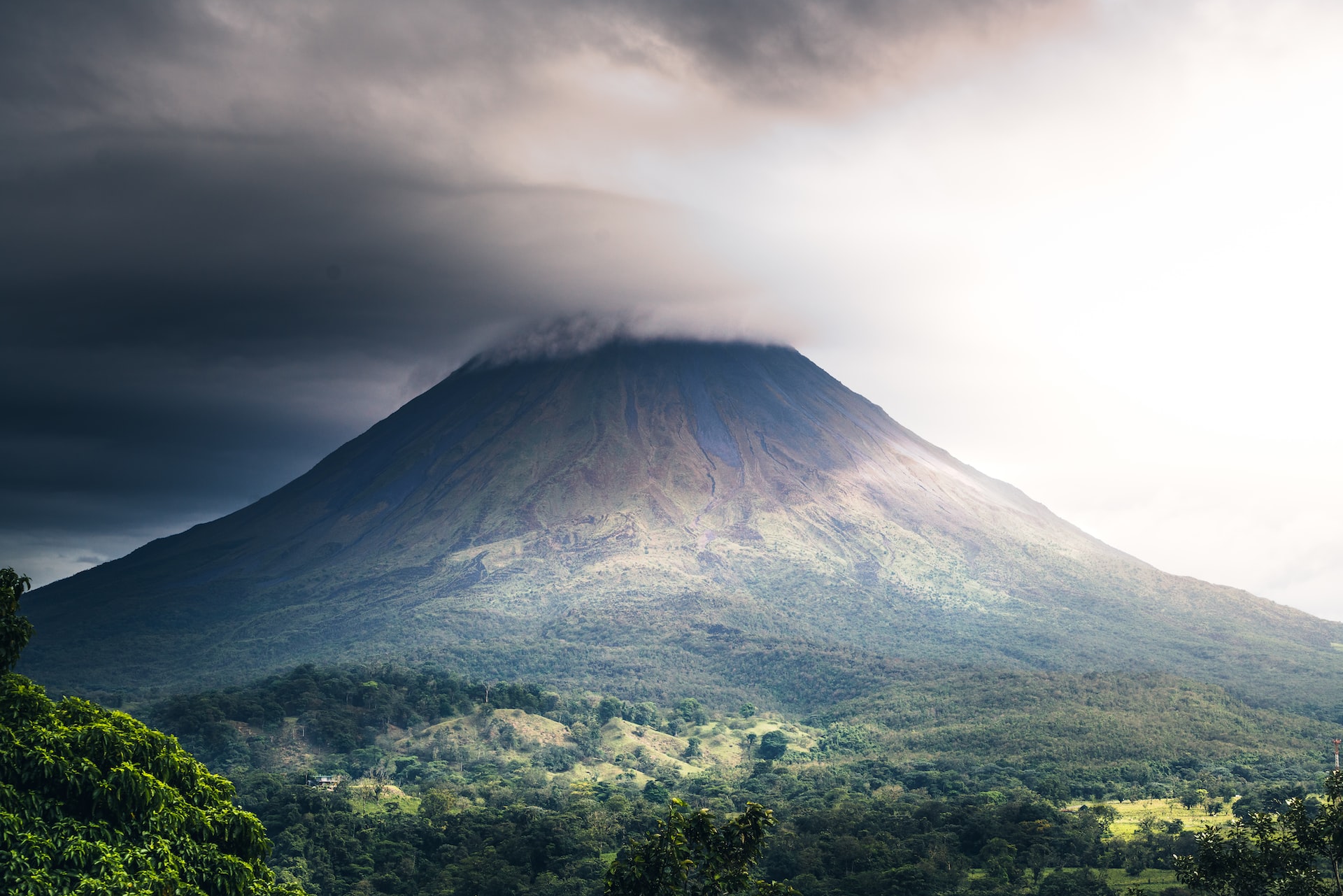 The peak of a large mountain in Costa Rica obscured by clouds.