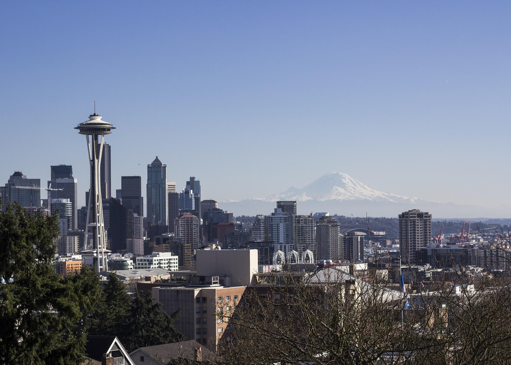 Mount Rainier in the distance of downtown Seattle, with the Space Needle visible.