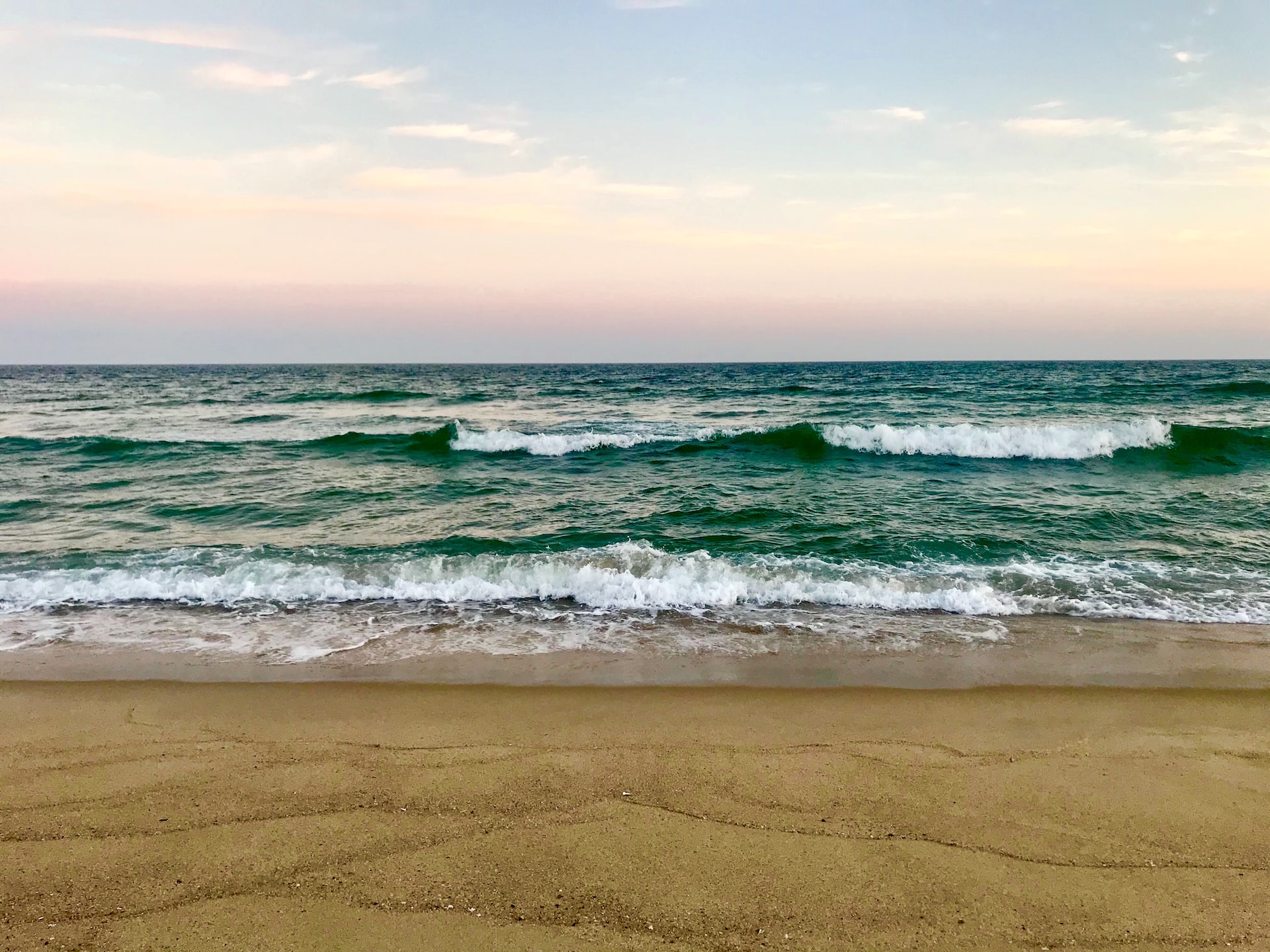 Waves rolling onto shore on a beach.