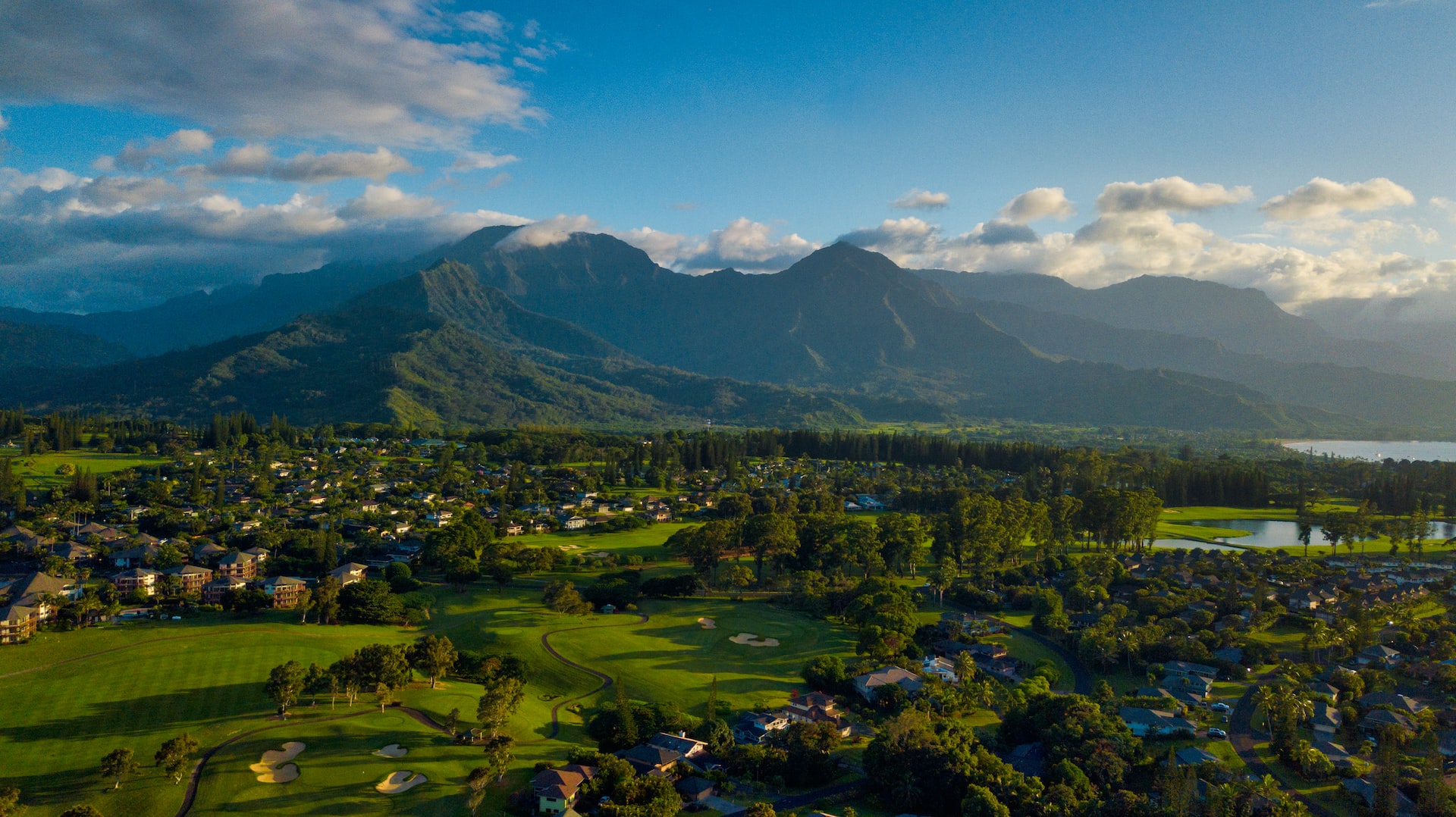 The town of Pinceville with large volcanic mountains rising in the distance.