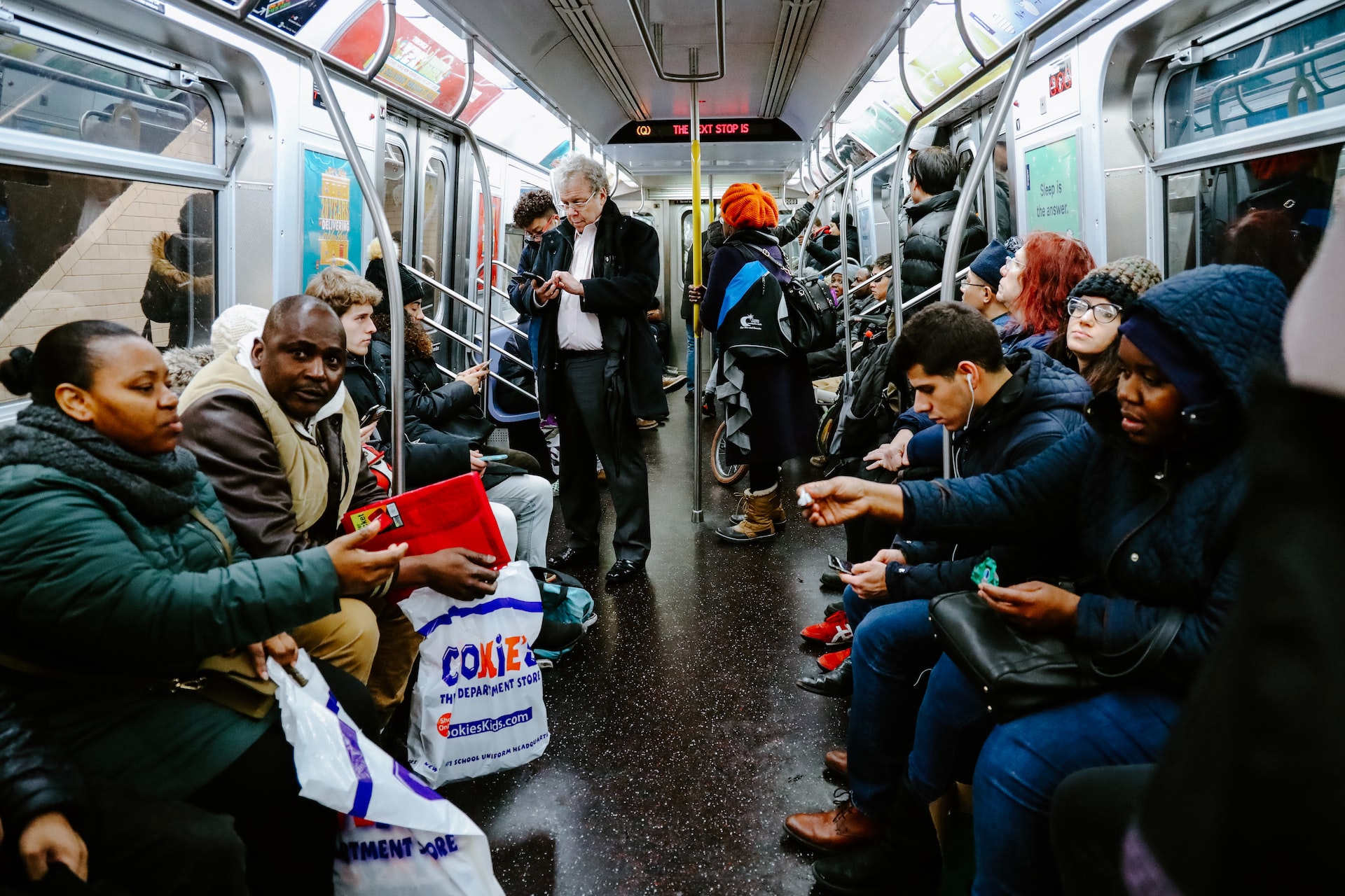 A diverse amount of people riding the subway in New York City.