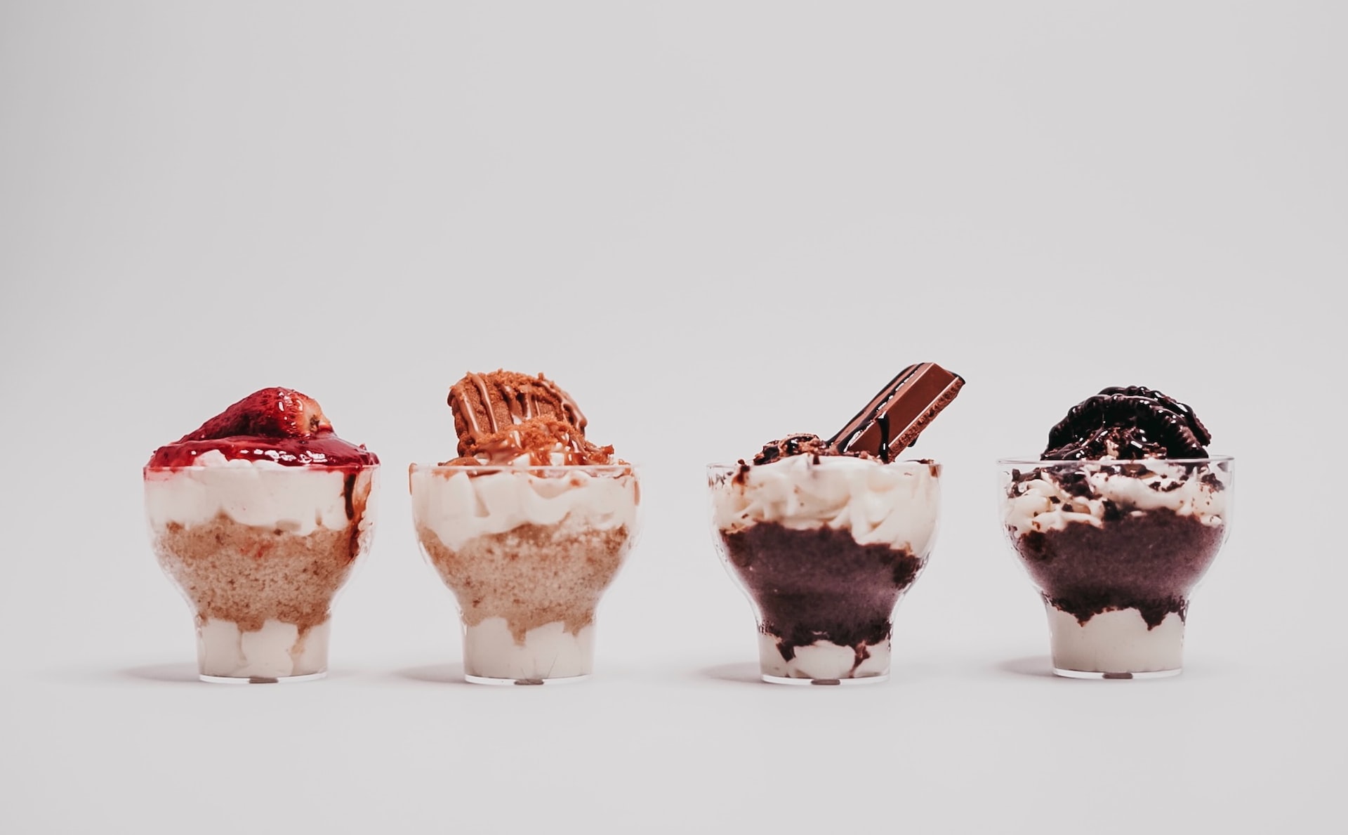 Four cupcake-like confections in glassware.