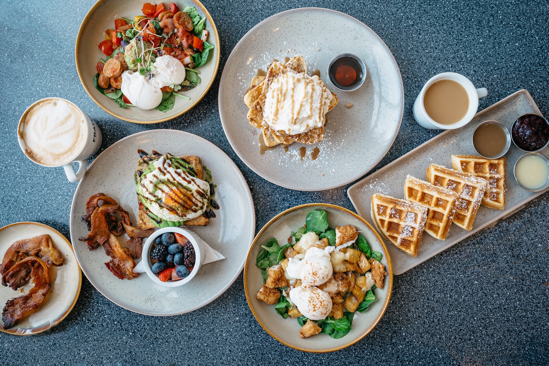 A decadent arrangement of brunch on multiple plates.