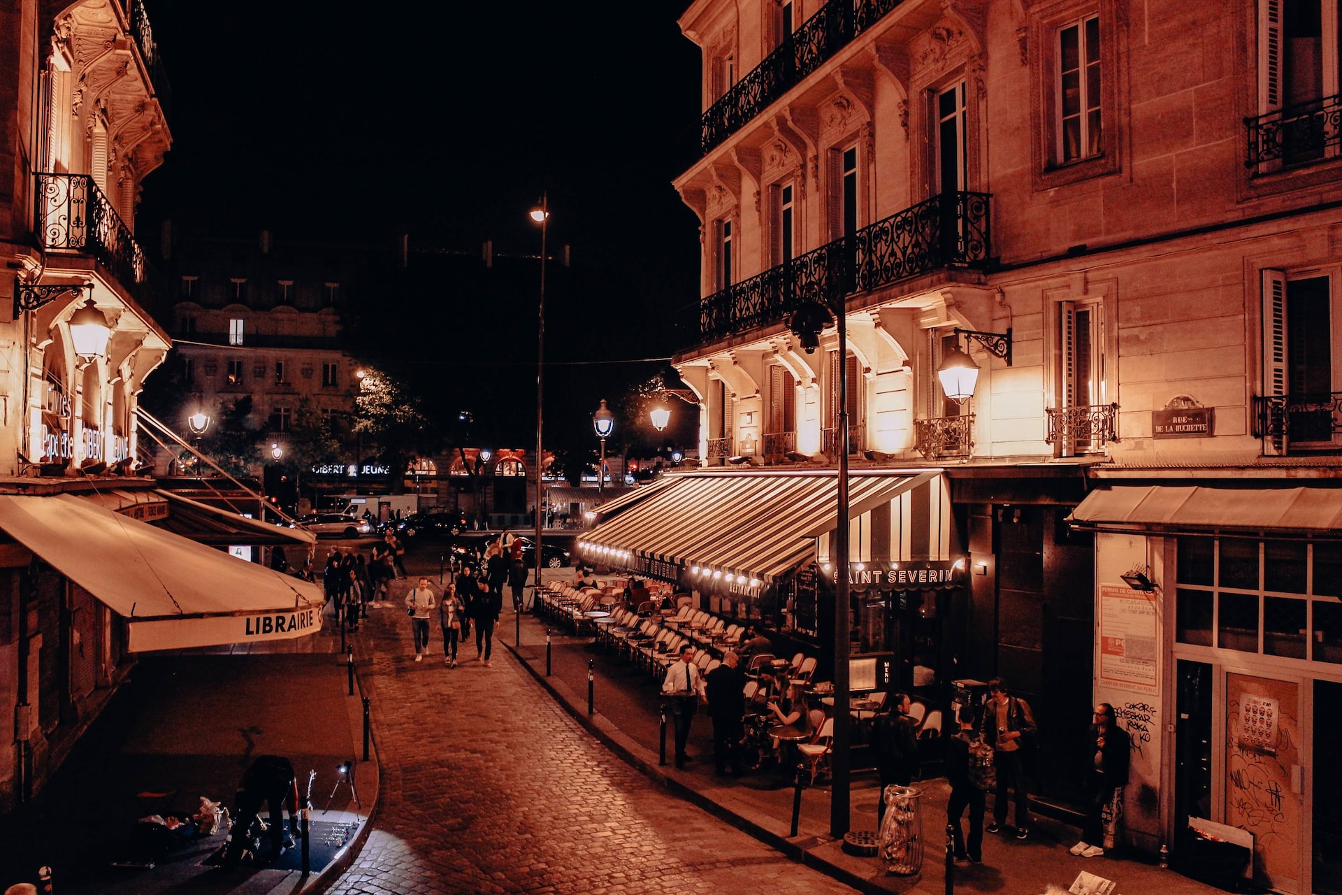 People walking in the Latin Quarter at night.
