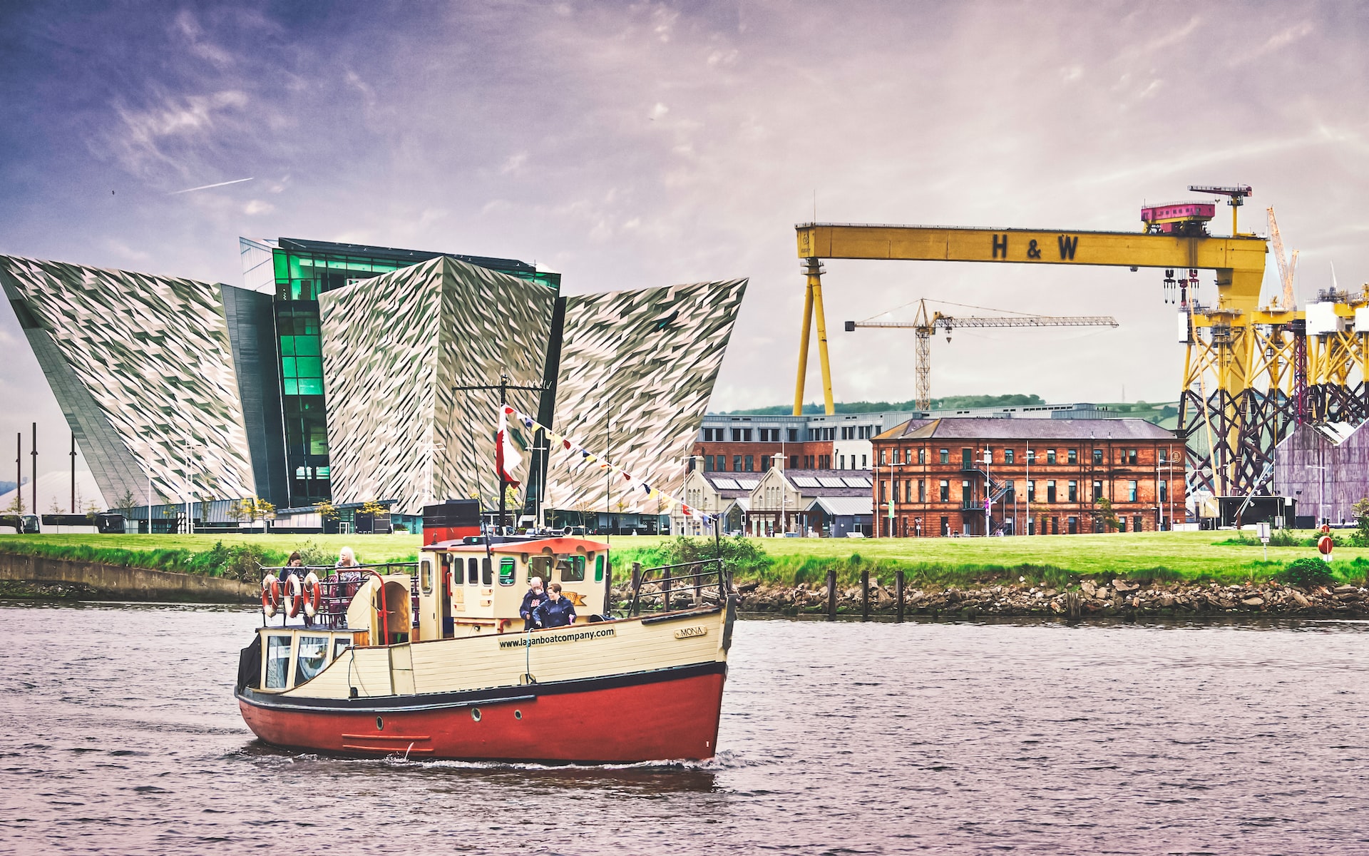 Three Belfast landmarks in one shot. From left to right: Titanic Belfast, a museum for all things Titanic related; the very large Harland and Wolffe ship building crane Goliath; and immediately below it, the red bricked building where the Titanic was designed by Harland and Wolff.