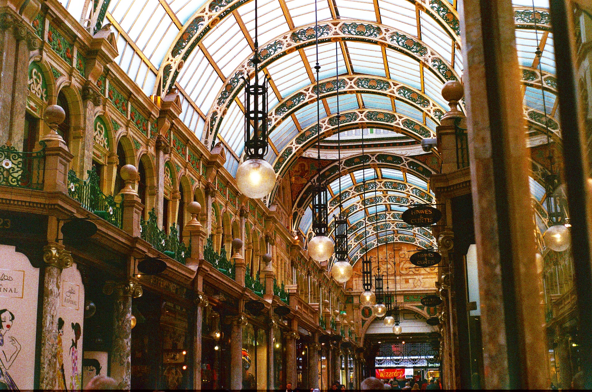 A row of fancy shops covered by a glass overhang.