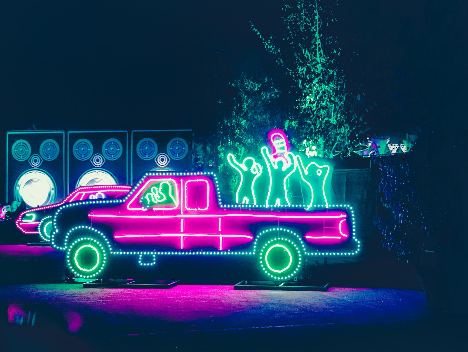 A lit-up truck at the race track during Christmas.