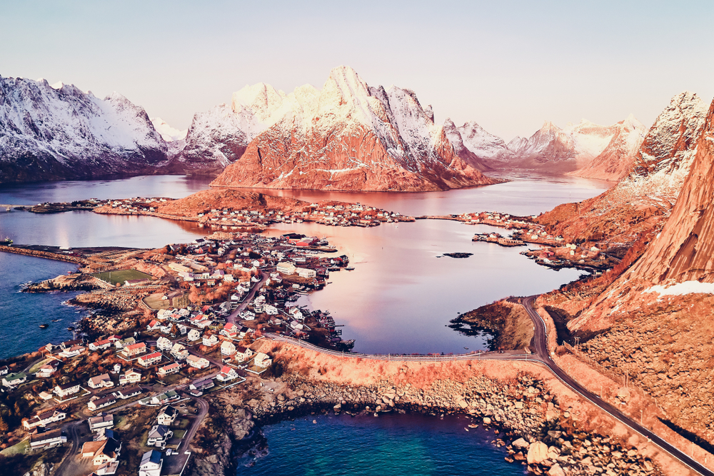 Mammoth Lakes with snow-covered peaks and an aerial view of the lake and community.