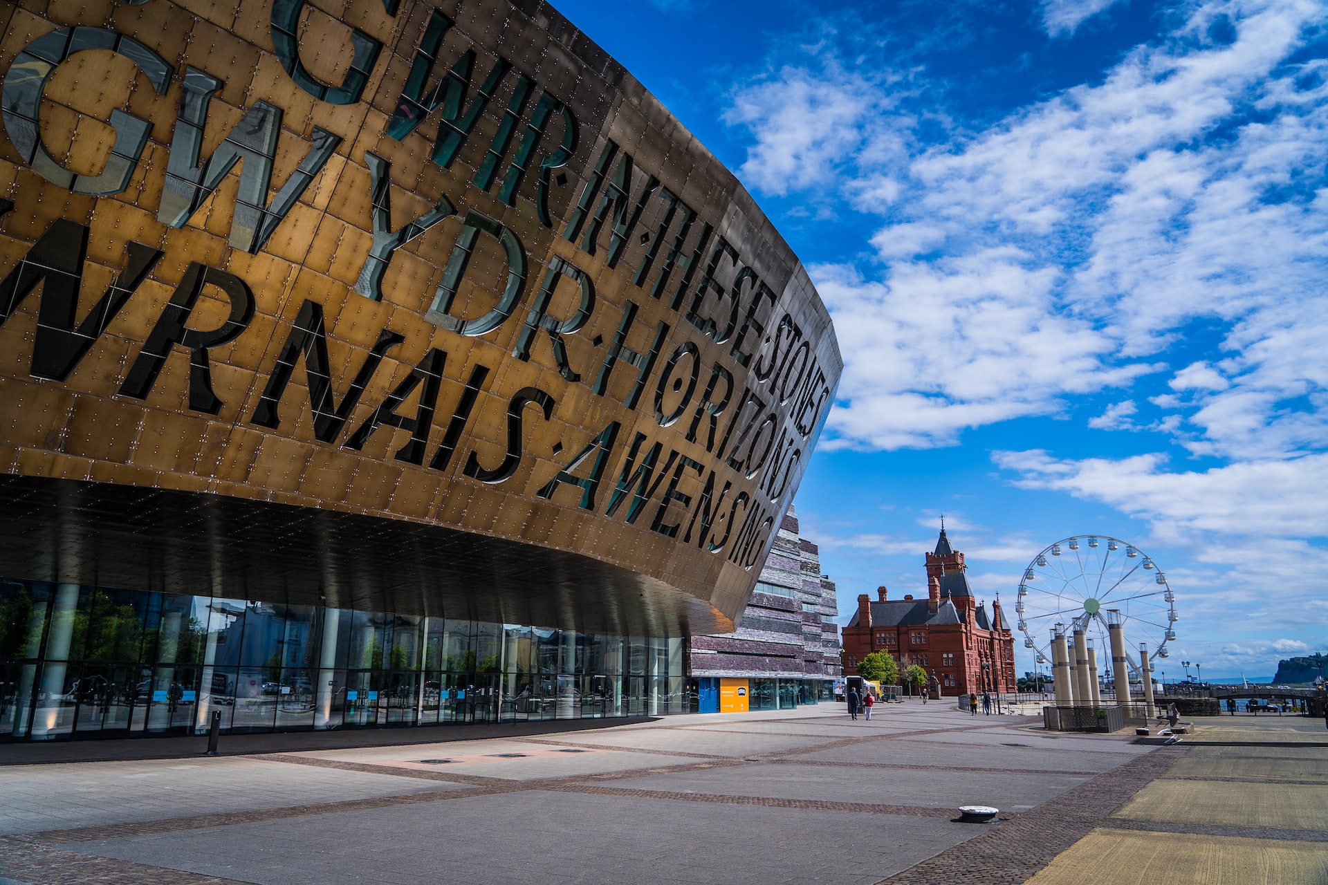 Cardiff Bay during the day time with a Ferris wheel and the Millennium Centre.