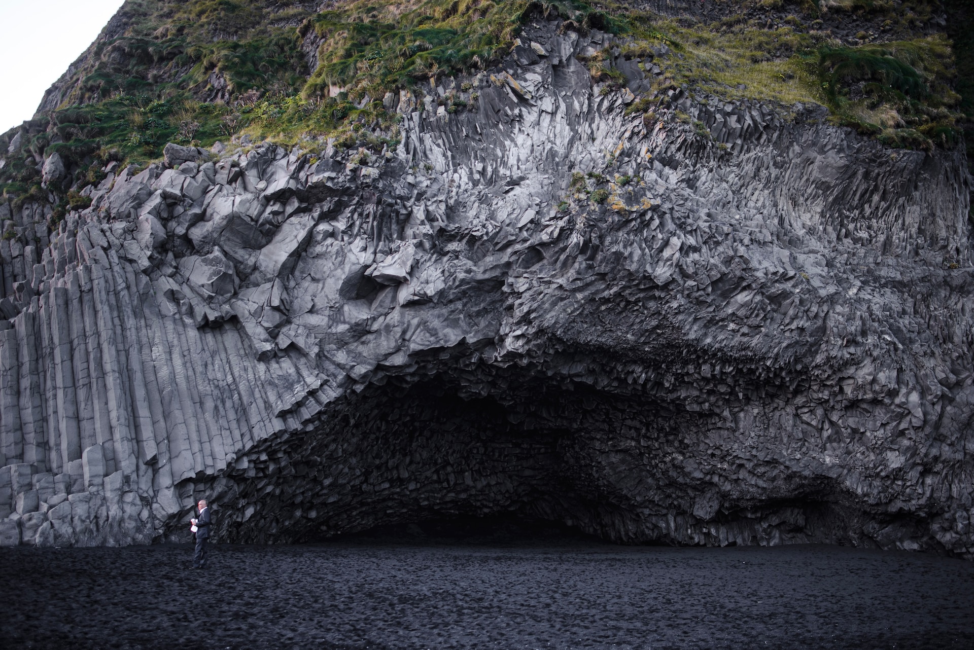 A rock overhang and a cave along the shore in Iceland.