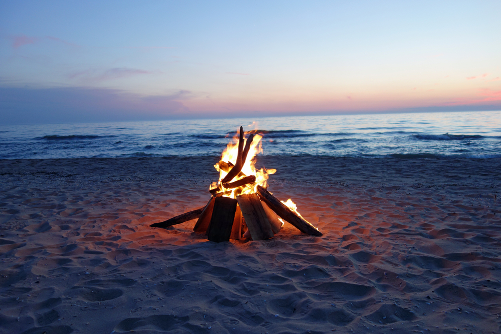 Inviting campfire on the beach during the summer.
