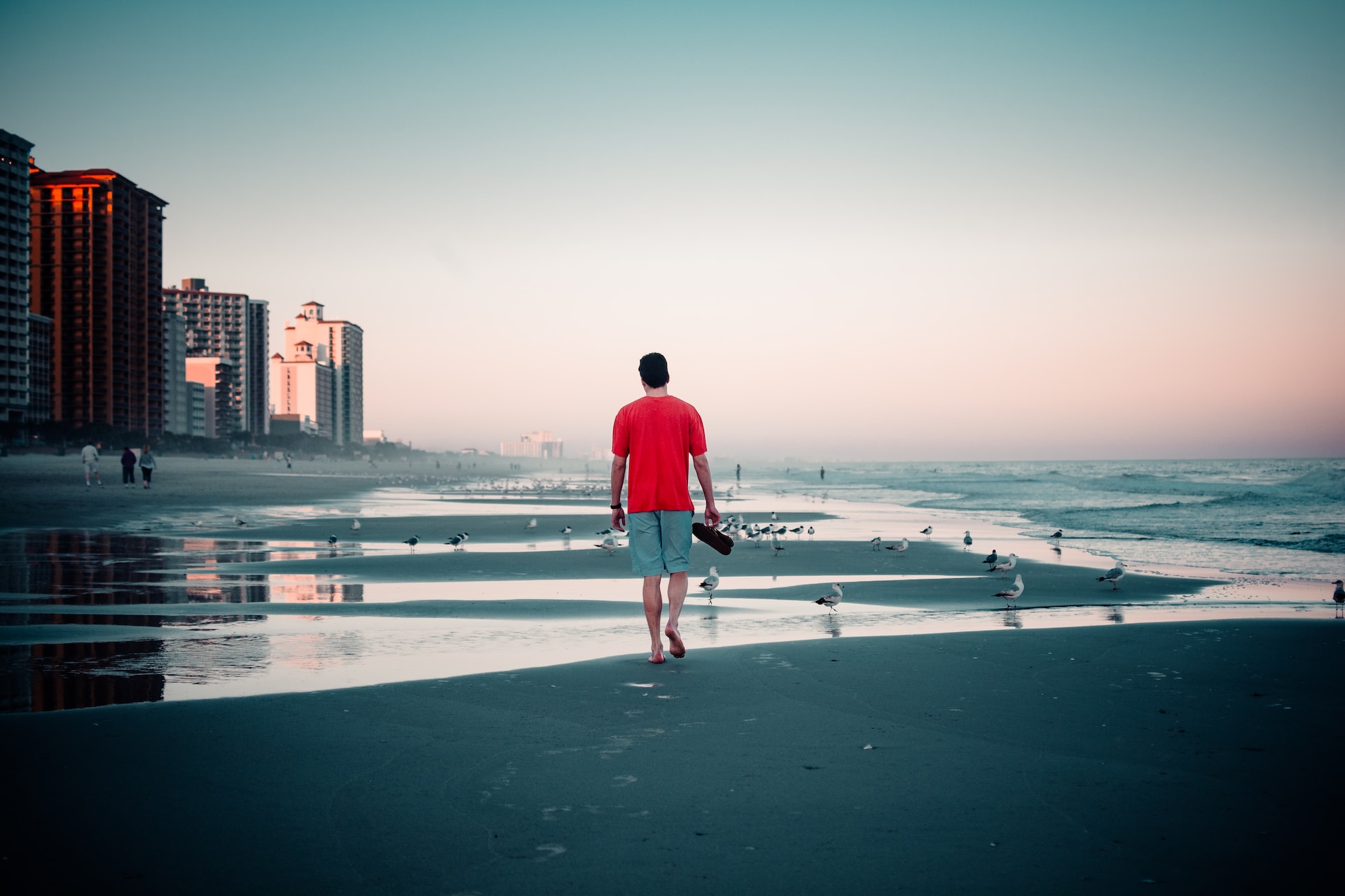 A man walking along the sand in Myrtle Beach.