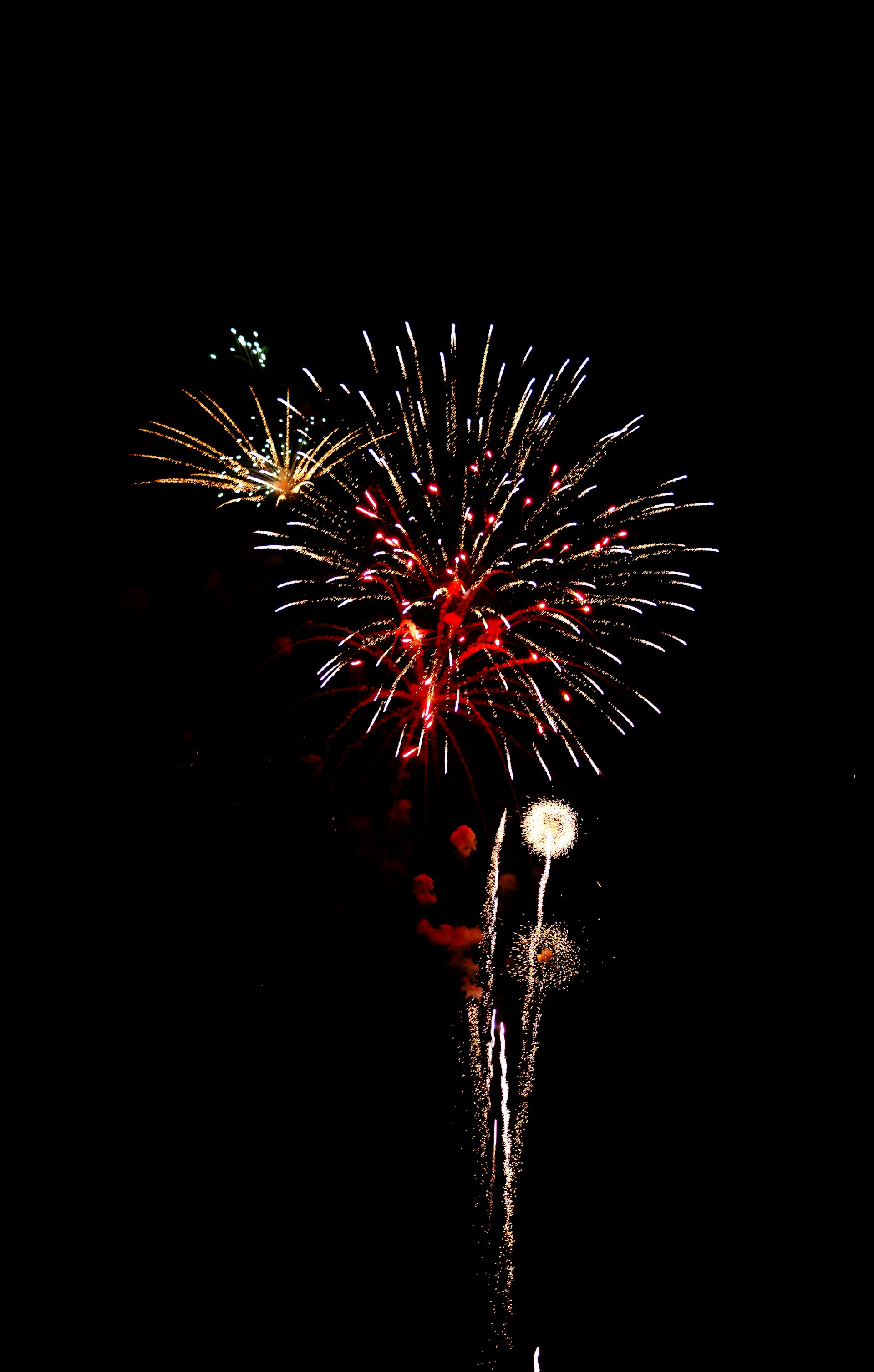Red fireworks bursting in the night sky in Destin Florida
